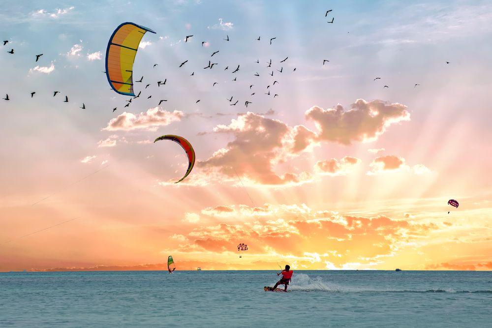 People parasailing and enjoying Aruba watersports